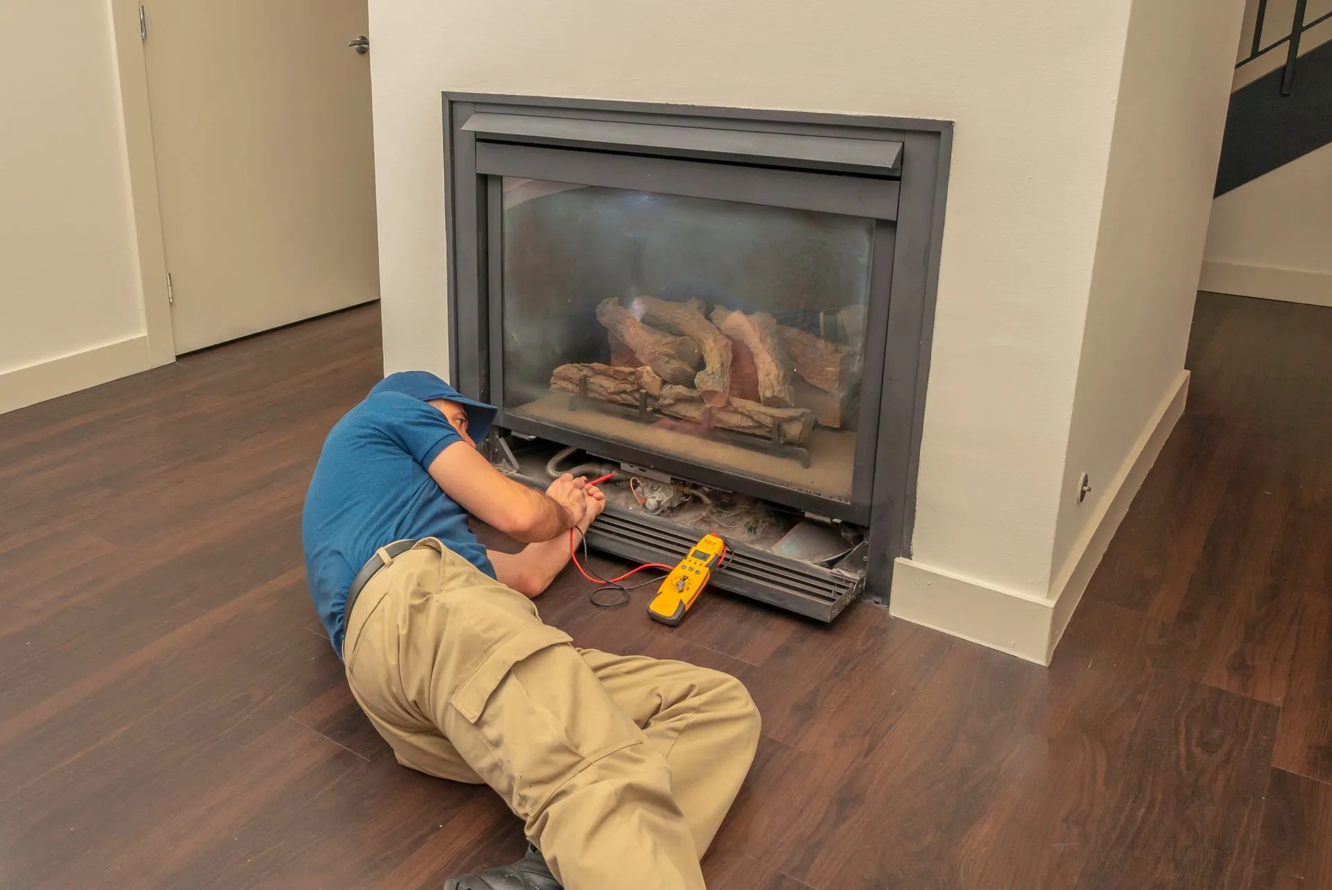 Technician servicing a gas fireplace